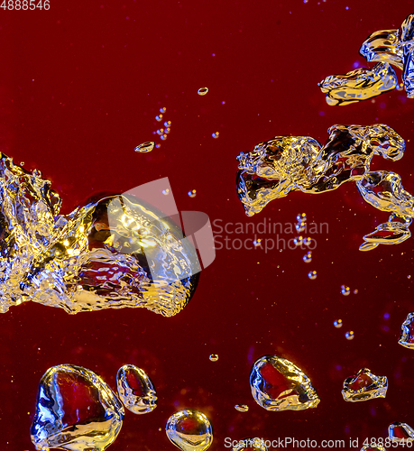 Image of Close up view of the cold and fresh cola with bright bubbles in neon light