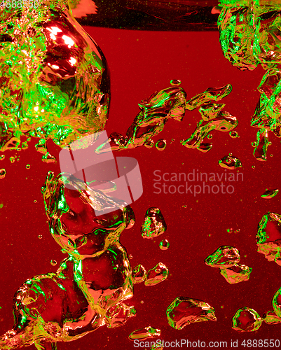 Image of Close up view of the cold and fresh cola with bright bubbles in neon light