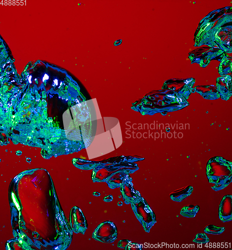 Image of Close up view of the cold and fresh cola with bright bubbles in neon light