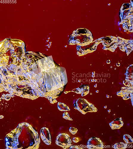 Image of Close up view of the cold and fresh cola with bright bubbles in neon light