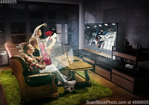 Image of Group of friends watching martial arts, sport together