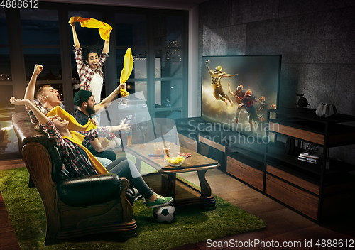 Image of Group of friends watching TV, american football match, sport together