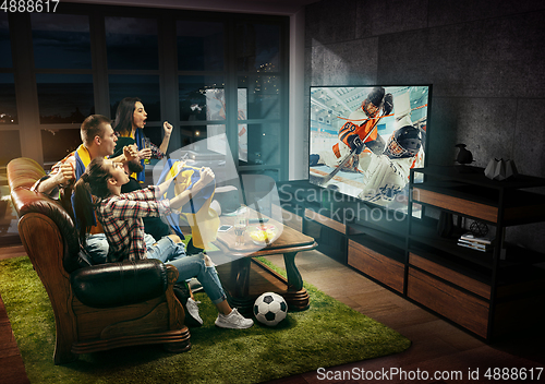 Image of Group of friends watching hockey match, sport together