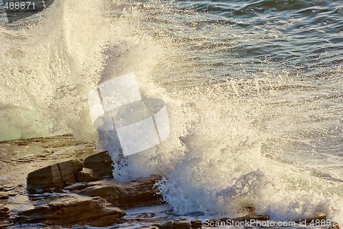 Image of crashing waves on rocks