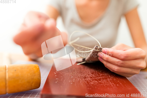 Image of Leather handbag craftsman at work in a workshop