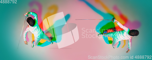 Image of Teen girl in fencing costume with sword in hand on gradient background with neon light, top view