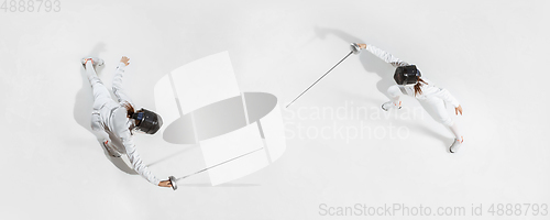 Image of Teen girl in fencing costume with sword in hand isolated on white background, top view