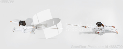 Image of Teen girl in fencing costume with sword in hand isolated on white background, top view