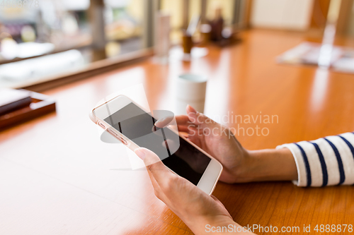 Image of Using cellphone in restaurant