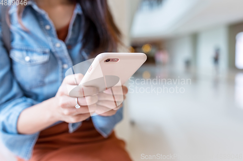 Image of Woman working on cellphone