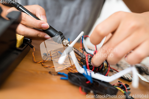 Image of Connecting the parts of drone with welding tool