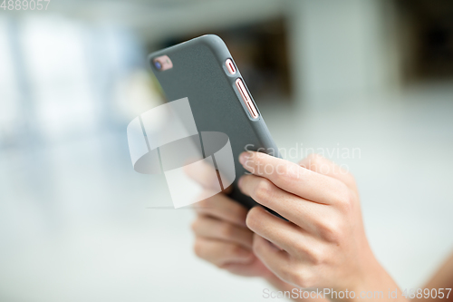 Image of Woman sending sms on mobile phone