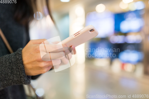 Image of Woman sending text message on smart phone