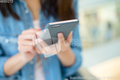 Image of Woman sending message with smartphone