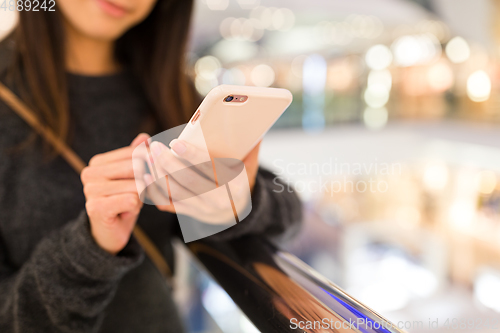 Image of Woman working on mobile phone