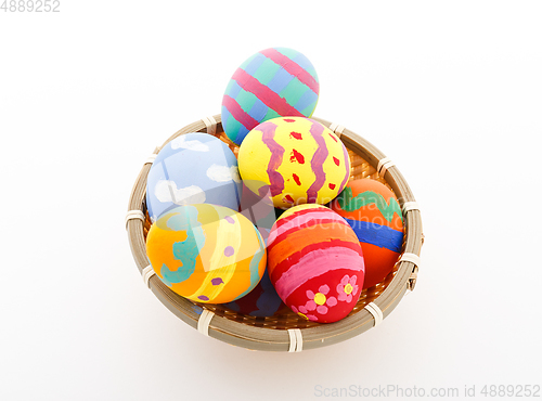 Image of Child painted Easter egg in basket