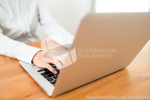 Image of Woman using laptop computer at home