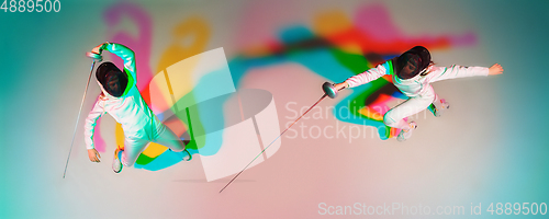 Image of Teen girl in fencing costume with sword in hand on gradient background with neon light, top view