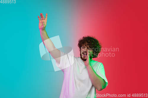 Image of Caucasian young man\'s portrait on gradient studio background in neon