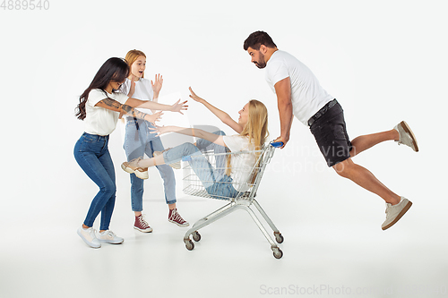 Image of Group of adorable multiethnic friends having fun isolated over white studio background