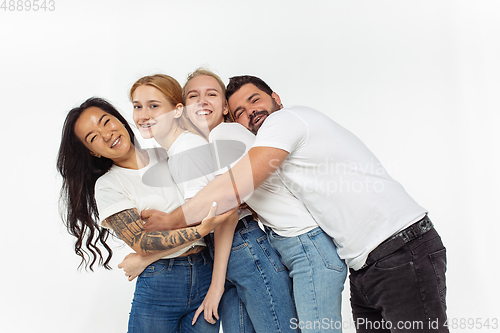 Image of Group of adorable multiethnic friends having fun isolated over white studio background