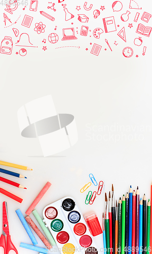 Image of Colorful school supplies corner border over a white background with negative space