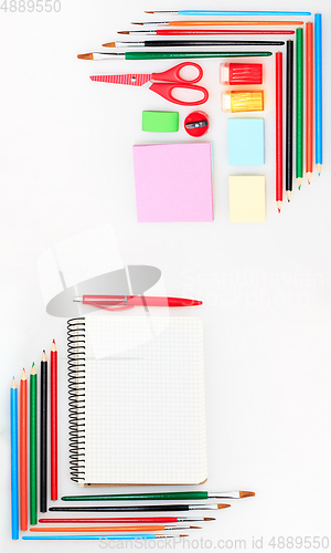 Image of Colorful school supplies corner border over a white background with negative space