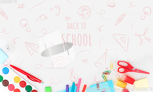 Image of Colorful school supplies corner border over a white background with words Back to school