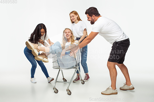 Image of Group of adorable multiethnic friends having fun isolated over white studio background