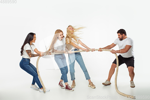 Image of Group of adorable multiethnic friends having fun isolated over white studio background