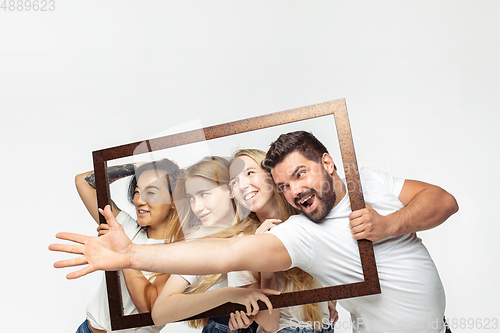 Image of Group of adorable multiethnic friends having fun isolated over white studio background