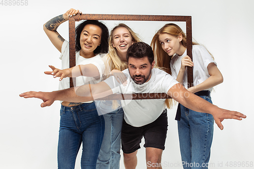 Image of Group of adorable multiethnic friends having fun isolated over white studio background