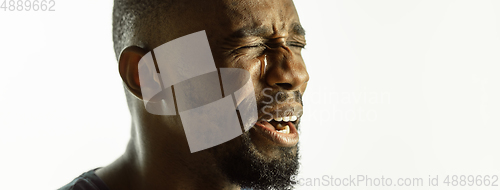 Image of African-american young man\'s close up shot on studio background, flyer