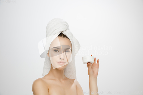 Image of Beauty Day. Woman wearing towel isolated on white studio background