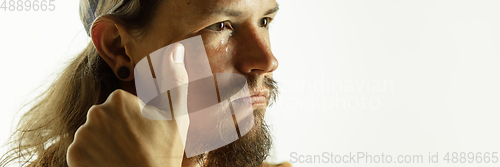 Image of Caucasian young man\'s close up shot on studio background, flyer