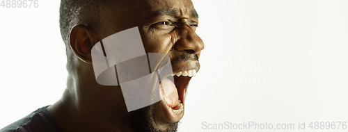 Image of African-american young man\'s close up shot on studio background, flyer