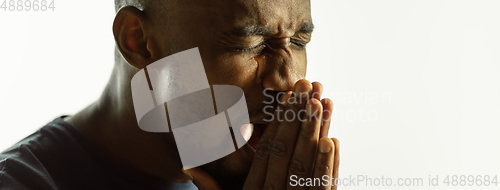Image of African-american young man\'s close up shot on studio background, flyer