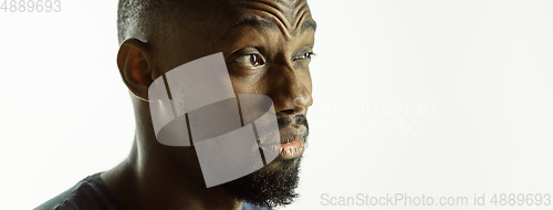 Image of African-american young man\'s close up shot on studio background, flyer