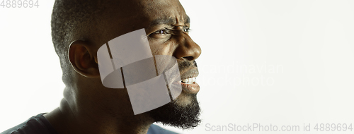 Image of African-american young man\'s close up shot on studio background, flyer