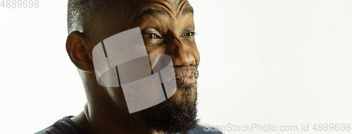 Image of African-american young man\'s close up shot on studio background, flyer
