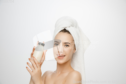 Image of Beauty Day. Woman wearing towel isolated on white studio background