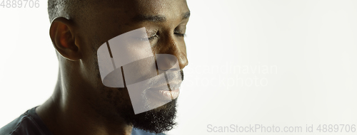 Image of African-american young man\'s close up shot on studio background, flyer