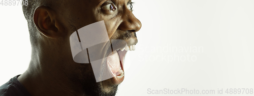 Image of African-american young man\'s close up shot on studio background, flyer