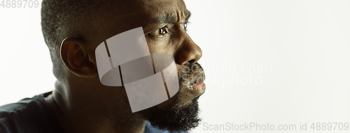 Image of African-american young man\'s close up shot on studio background, flyer