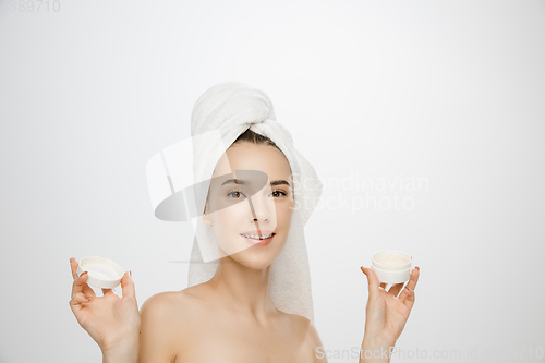 Image of Beauty Day. Woman wearing towel isolated on white studio background