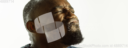 Image of African-american young man\'s close up shot on studio background, flyer