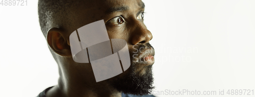 Image of African-american young man\'s close up shot on studio background, flyer