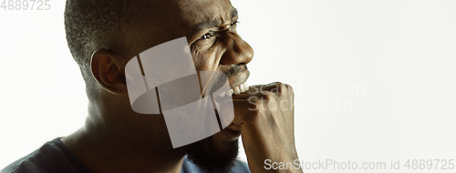 Image of African-american young man\'s close up shot on studio background, flyer