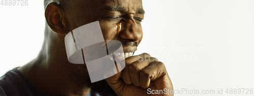 Image of African-american young man\'s close up shot on studio background, flyer