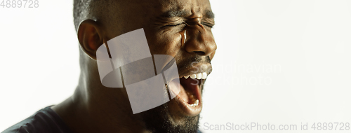 Image of African-american young man\'s close up shot on studio background, flyer